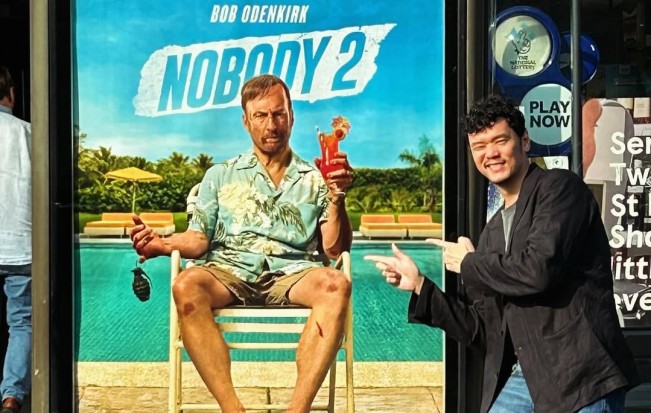 Timo Tjahjanto dan poster Nobody 2. (Instagram/@timobros)